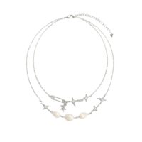 Silver plated double-layer necklace with sparkling star charms and baroque-style pearl accents
