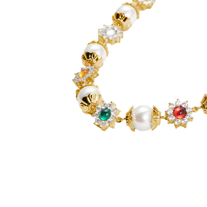 Close-up of daisy charms with colorful CZ stones on pearl station necklace