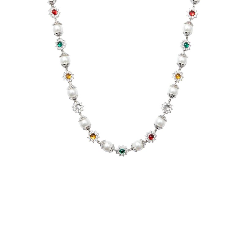 Studio angled view of daisy pearl necklace in silver tone with glass pearls and CZ-set floral charms