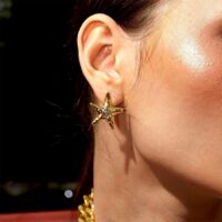 Gold Starfish Stud Earrings worn on ear, coastal chic everyday look