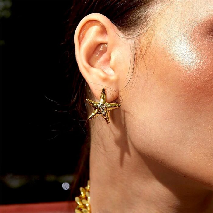 Gold Starfish Stud Earrings worn on ear, coastal chic everyday look