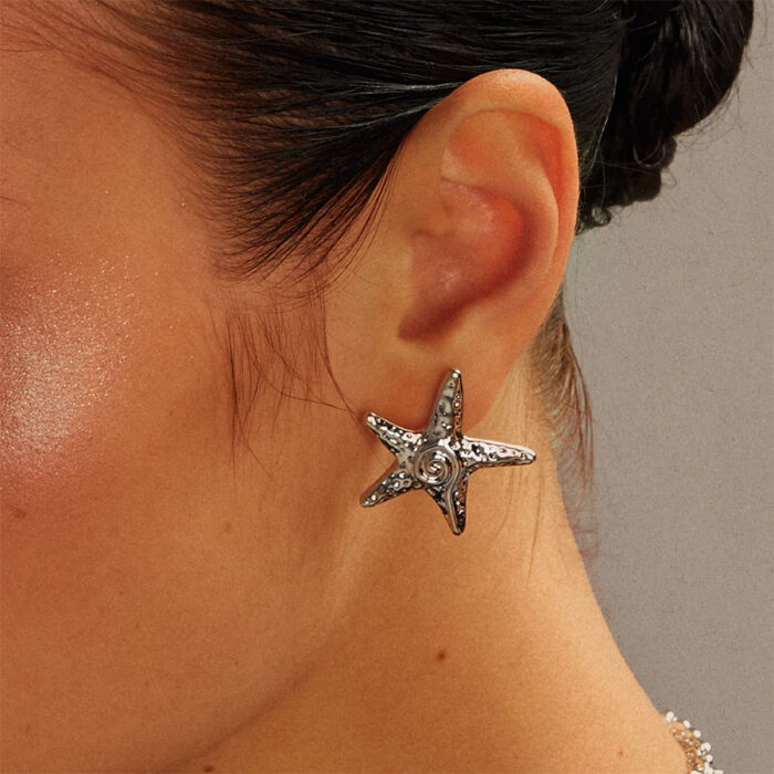 Silver starfish stud earring on ear for everyday wear, minimalist beach jewelry