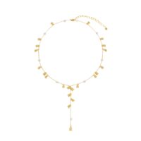 Minimalist pearl Y necklace styled on neckline