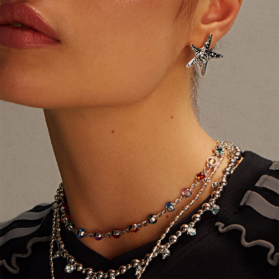 Ocean-inspired Silver Starfish Stud Earrings paired with multicolor bead necklace