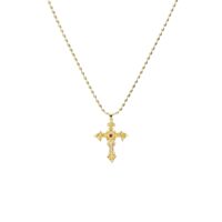 Gold-toned vintage filigree Aphrodite cross necklace with CZ stones and a red center gemstone on a white background.