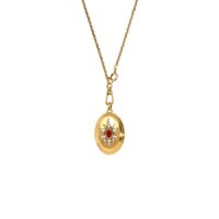 Celestial starburst gold locket pendant necklace with red center stone and clear crystals