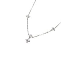cz lucky clover necklace close-up of bezel-set round CZ with dangling floral clover charm on white