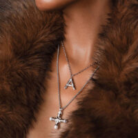 Florence Pearl Cross Necklace styled as a longer necklace with a pearl cross pendant and silver layering chains, coquette gothic jewelry look