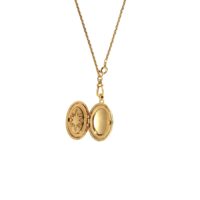 Open gold oval locket necklace showing starburst engraving and inner compartmen