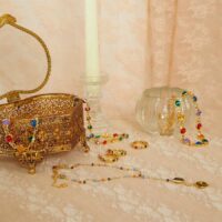 gold infinity choker necklace for women styled with rings and earrings for a colorful jewelry stack photo