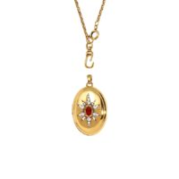 Gold-toned oval locket pendant necklace with crystal starburst detail and separate chain clasp