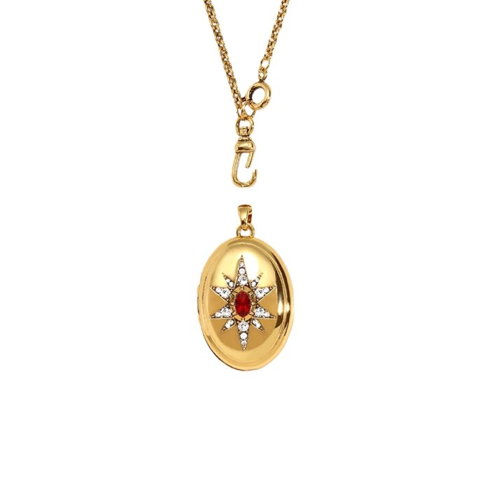 Gold-toned oval locket pendant necklace with crystal starburst detail and separate chain clasp