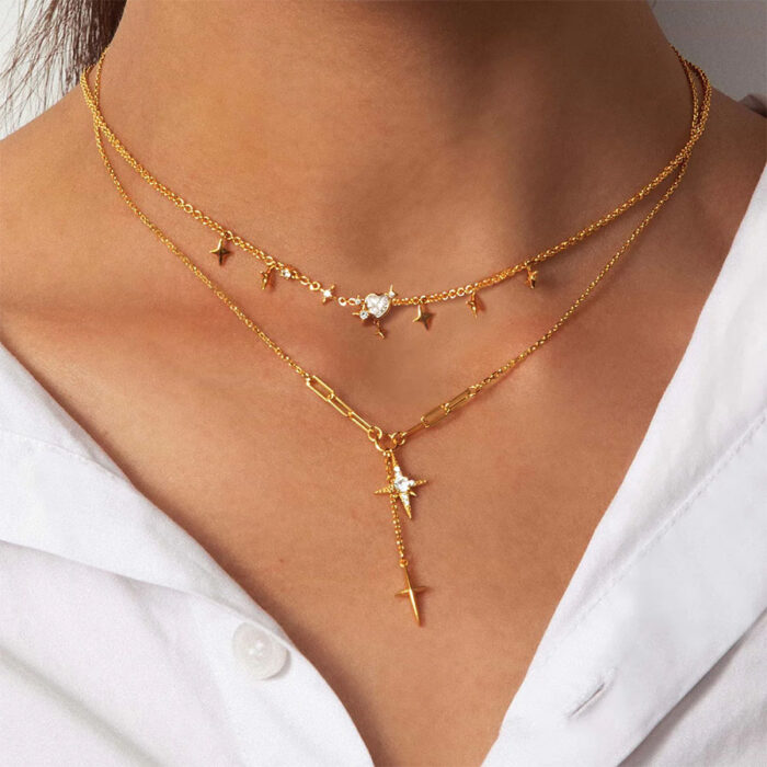 Melissa Gold Star Necklace on model —north star y necklace gold layered over a white collared shirt
