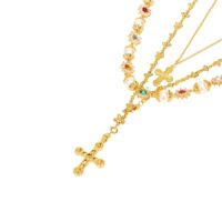 statement gold layered necklace for party featuring ornate crucifix and mini cross charms with pearl strand