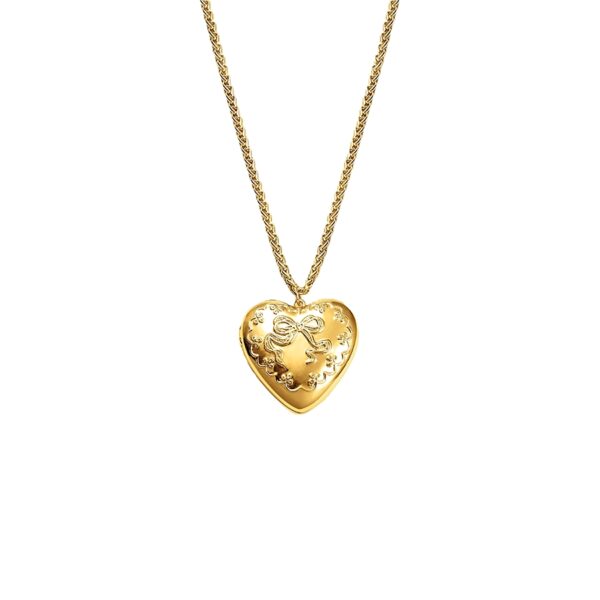 Tender heart locket necklace in 18k gold plated brass with embossed bow and floral details on a wheat chain