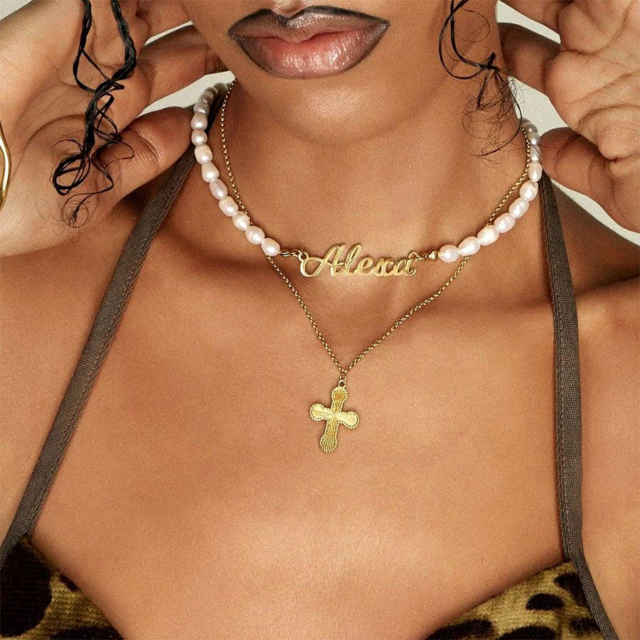 Textured cross pendant gold necklace in layered jewelry close-up for Reels/TikTok styling