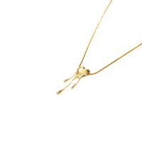 Close-up of Venom Golden Drip Heart Necklace 18k gold plated heart pendant with layered teardrop chains, street style accessories
