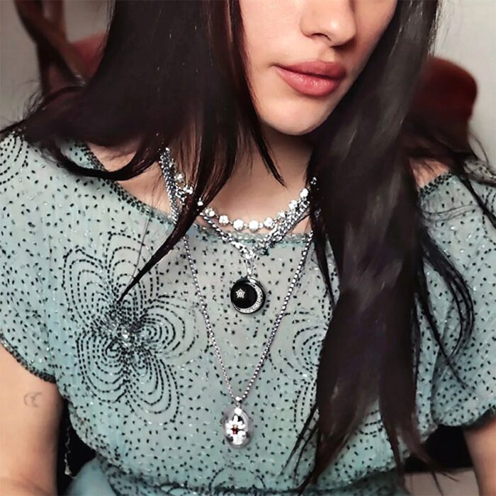 Celestial-core layered jewelry look with silver zeldas star openable locket necklace on model